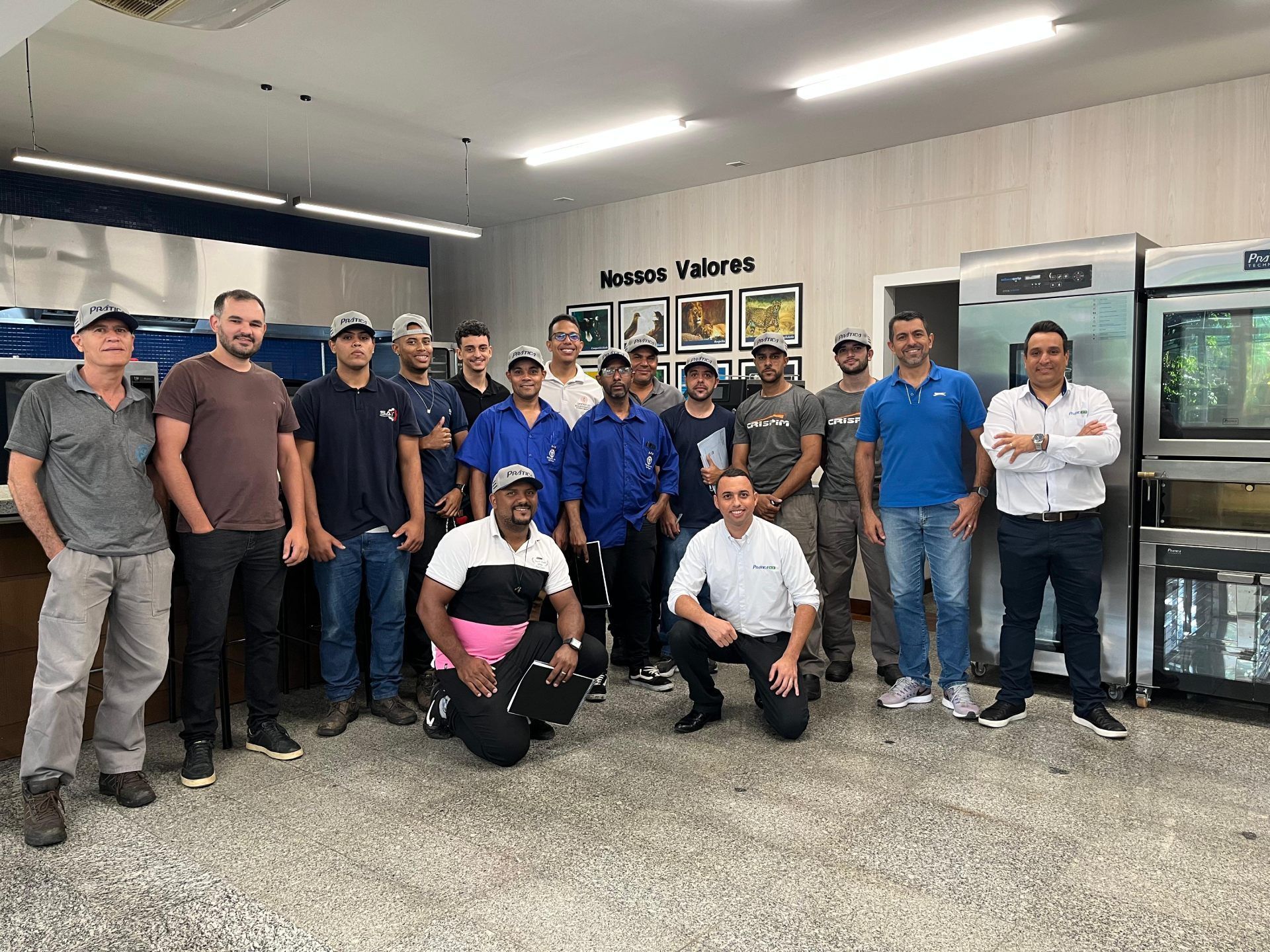Um grupo de homens está posando para uma foto em uma cozinha.