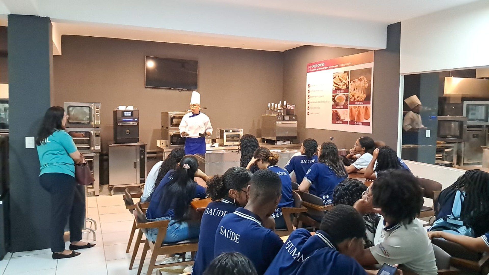 Um grupo de pessoas está sentado em mesas em um restaurante.