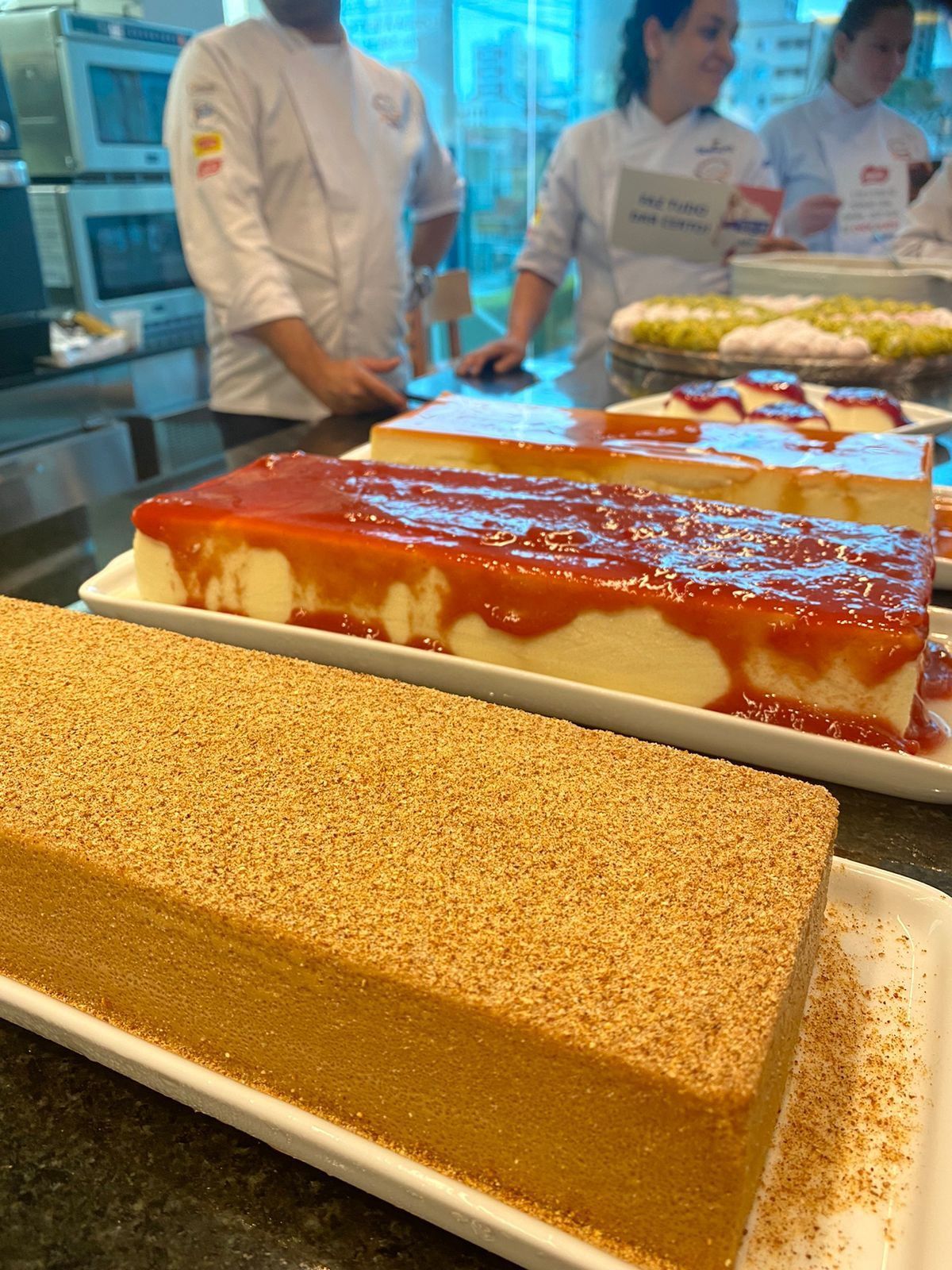 Um monte de bolos estão sobre uma mesa na cozinha