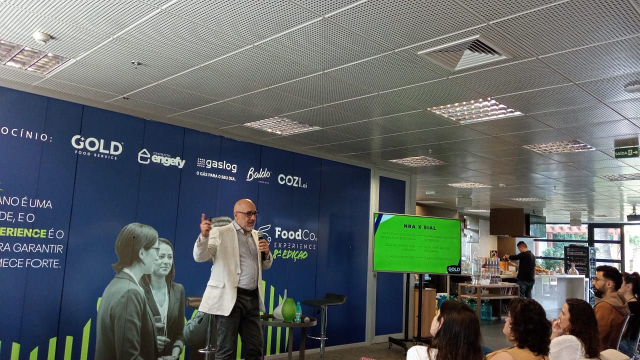 Um homem está fazendo uma apresentação para um grupo de pessoas em uma sala.