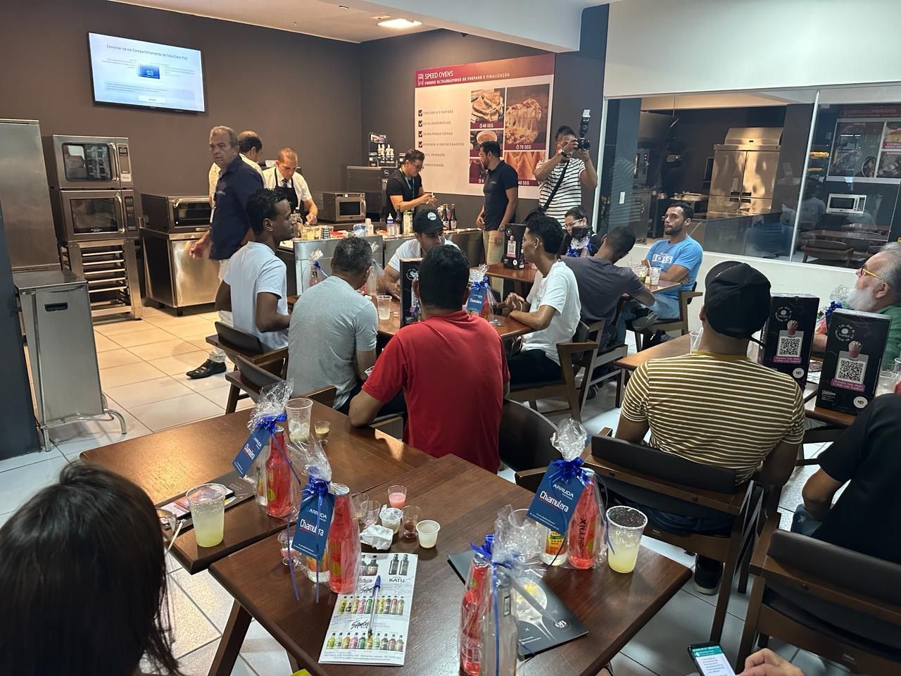 Um grupo de pessoas está sentado em mesas em um restaurante.