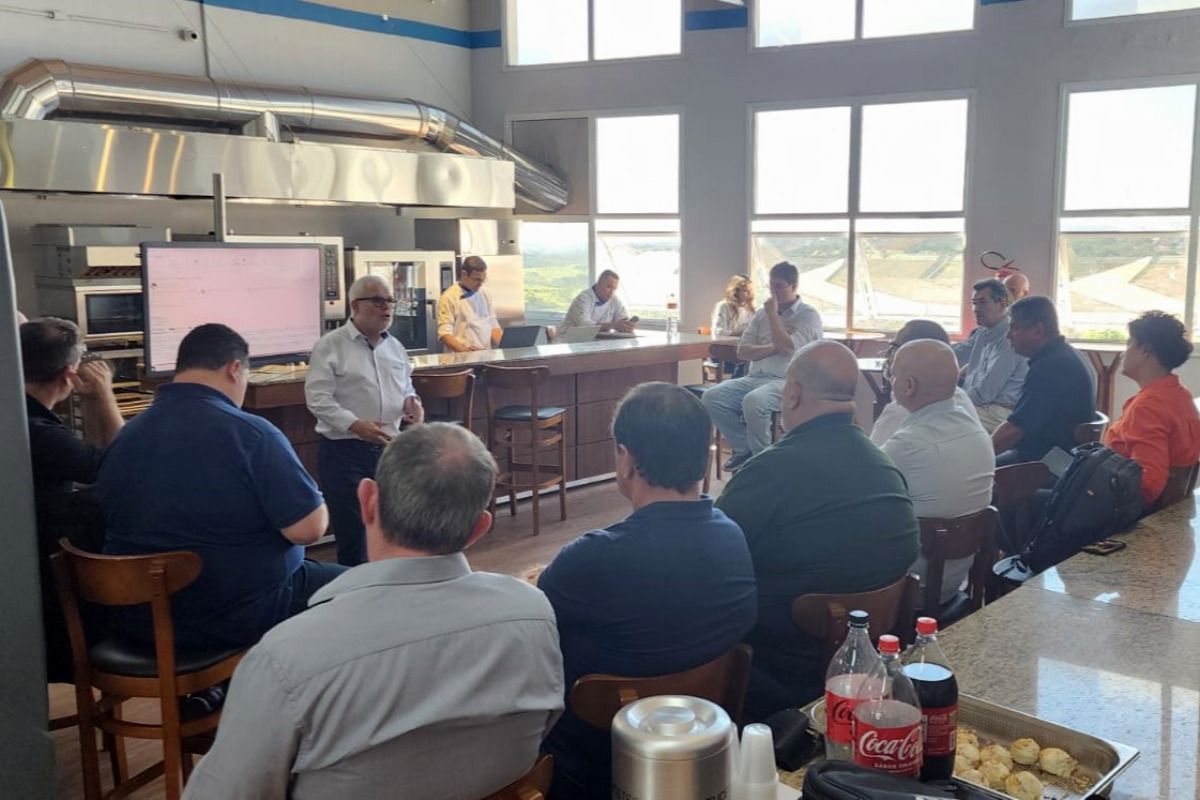 Um grupo de pessoas está sentado ao redor de uma mesa em um restaurante.