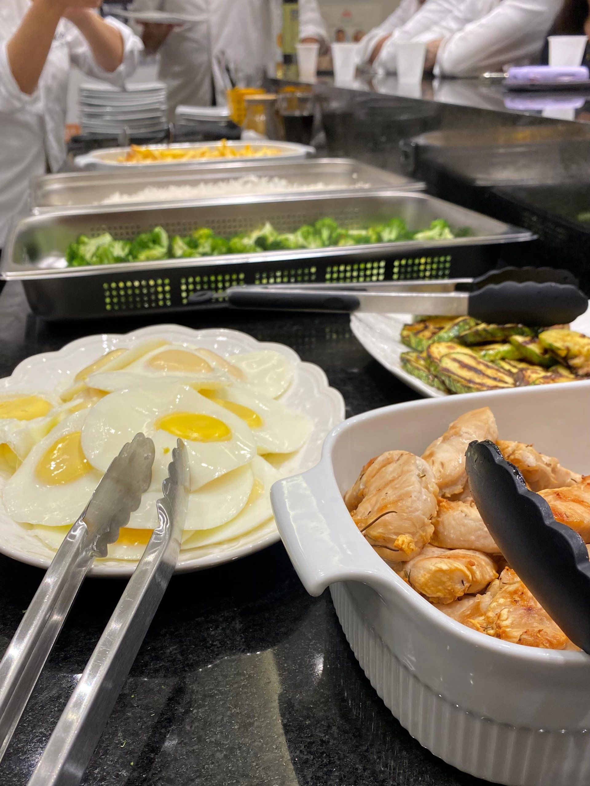 Uma mesa com pratos de comida e pinças sobre ela