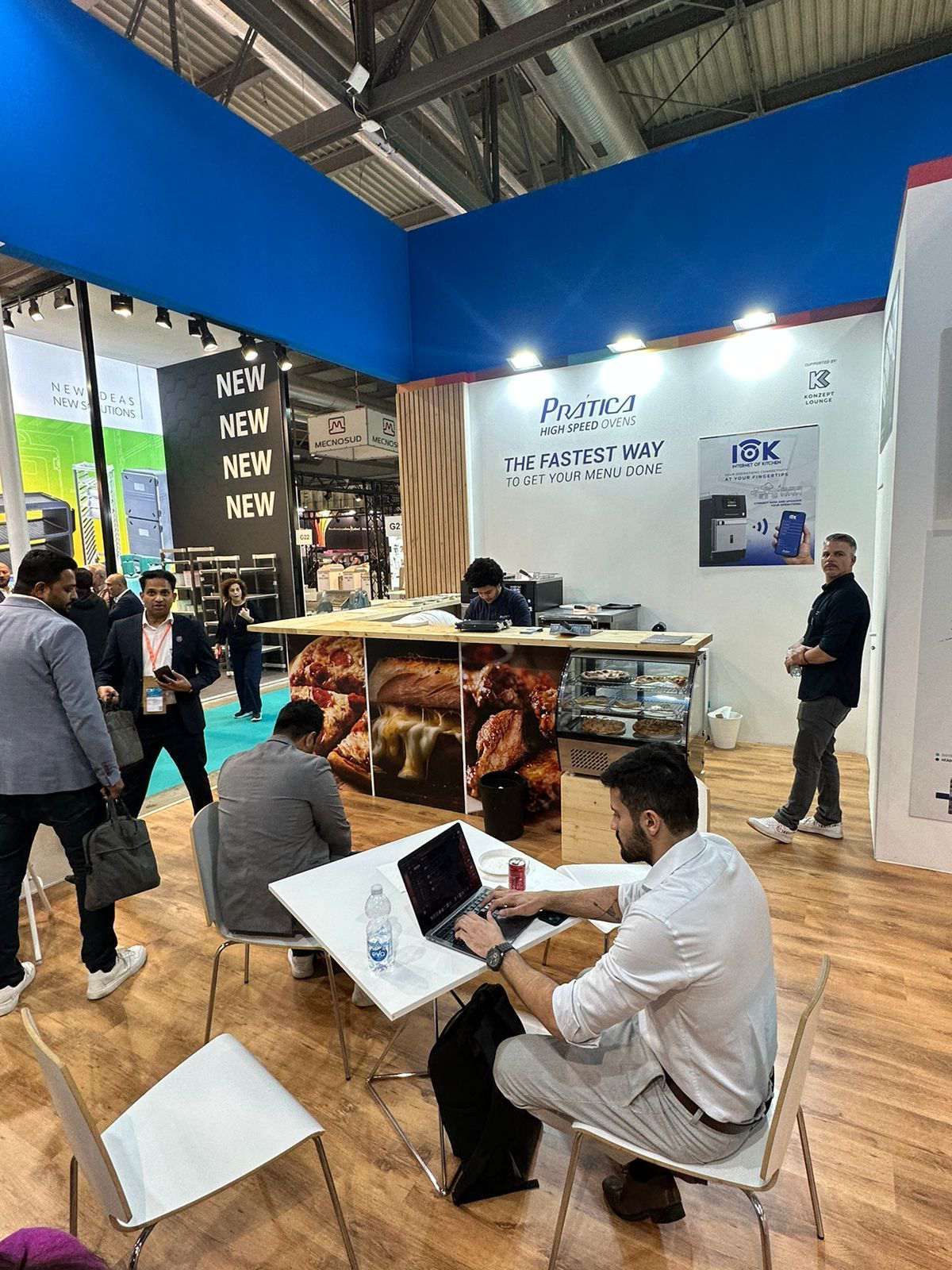 Um homem está sentado à mesa usando um laptop.