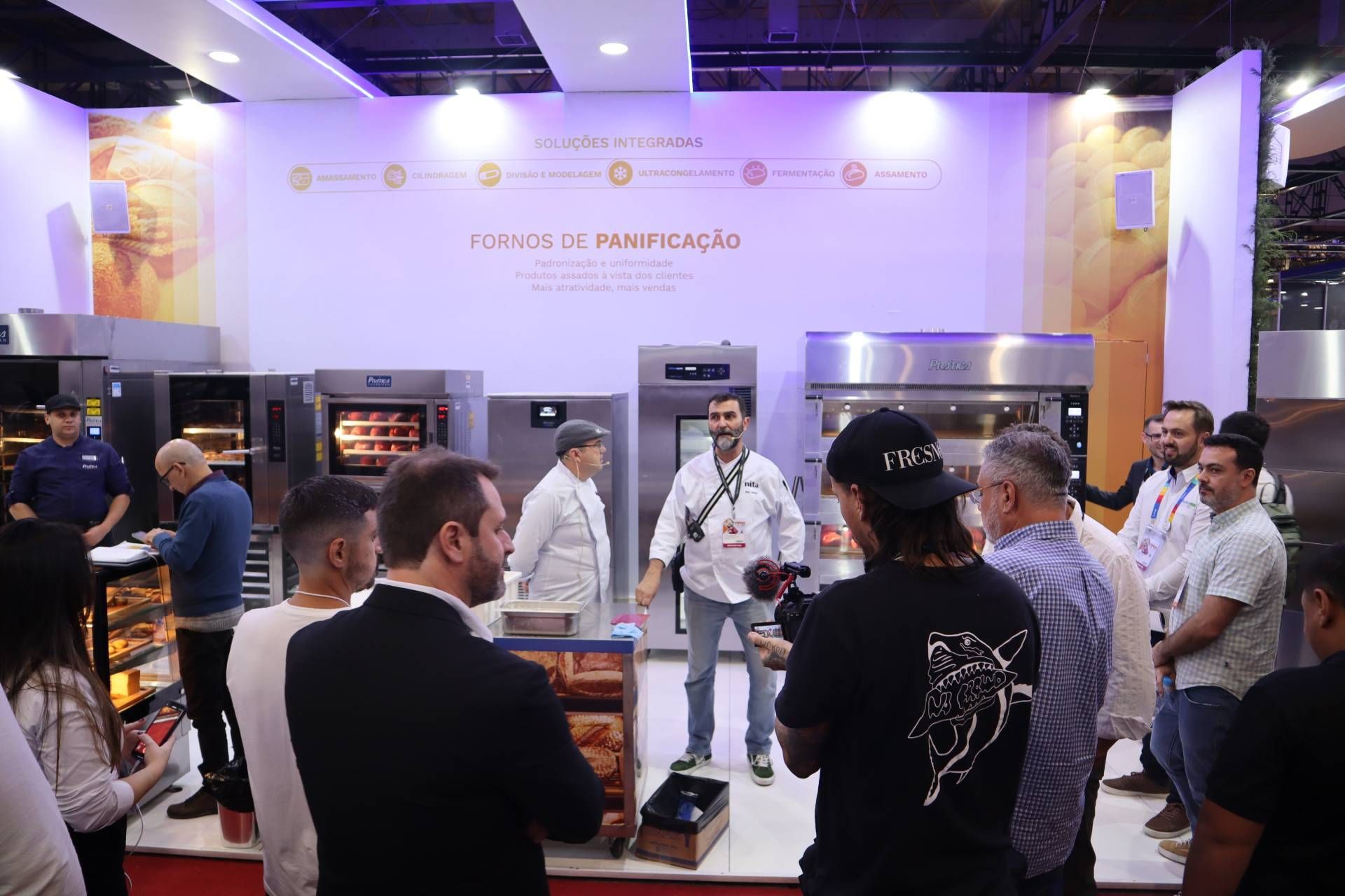 Um grupo de pessoas está em frente a uma padaria.