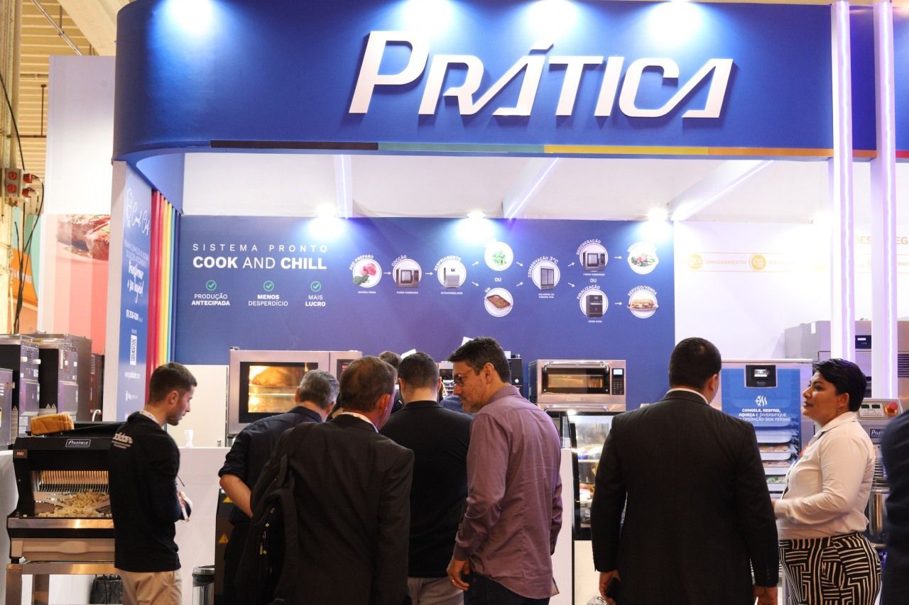 Um grupo de pessoas está em frente a um estande de prática