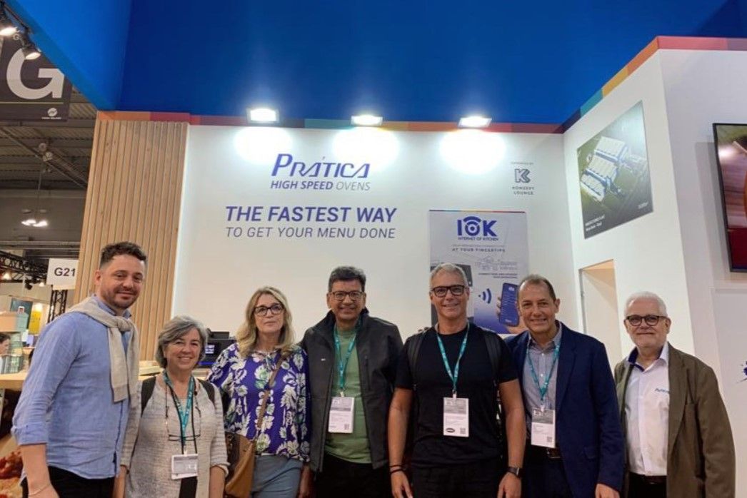 Um grupo de pessoas está posando para uma foto em uma convenção.