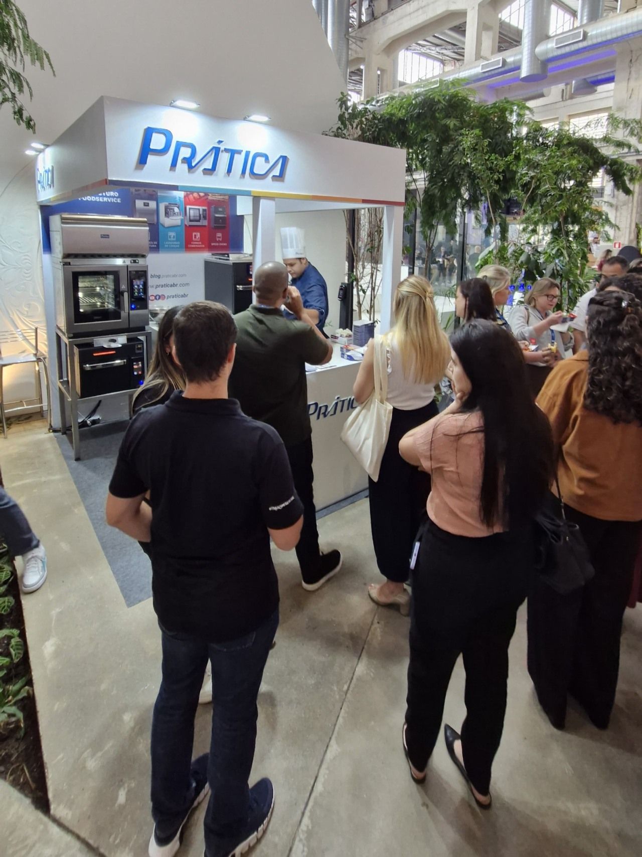 Um grupo de pessoas em pé em frente a uma placa de prática