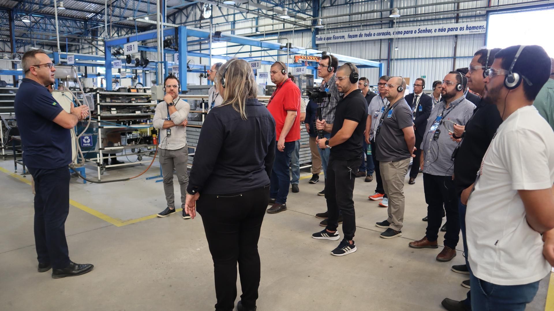 Um homem está conversando com um grupo de pessoas em um armazém.