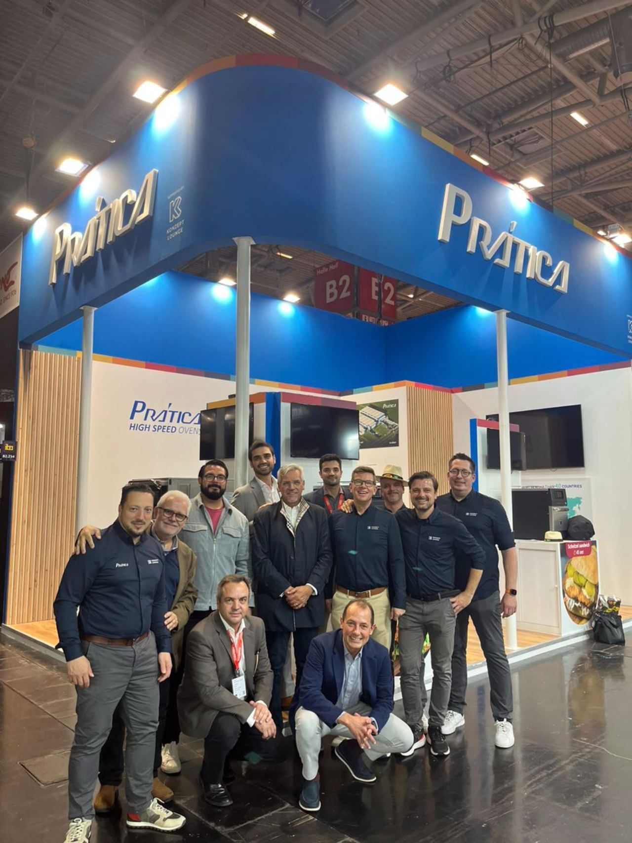 Um grupo de homens está posando para uma foto em frente a um estande de prática.