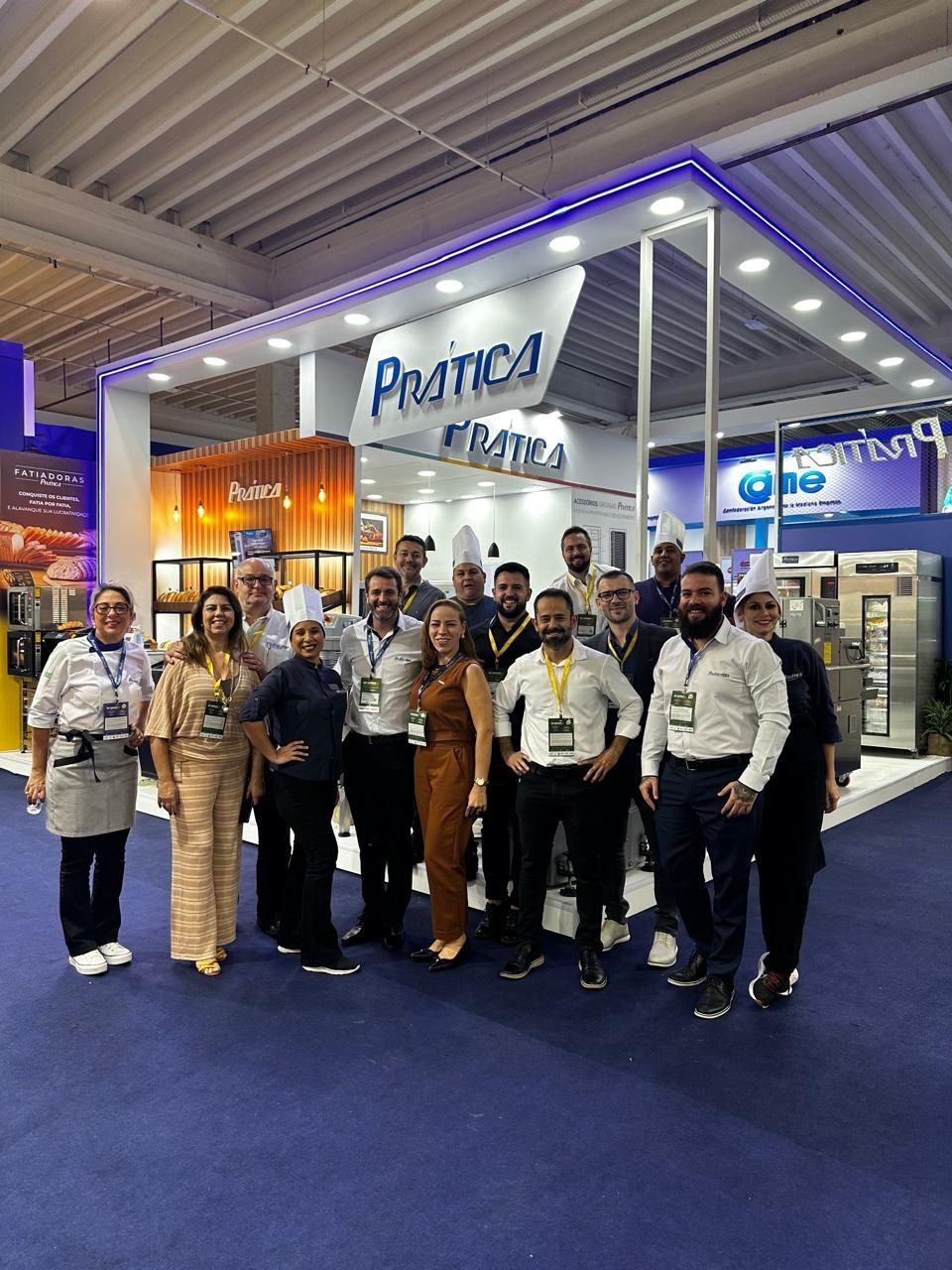 Um grupo de pessoas está posando para uma foto em uma convenção.