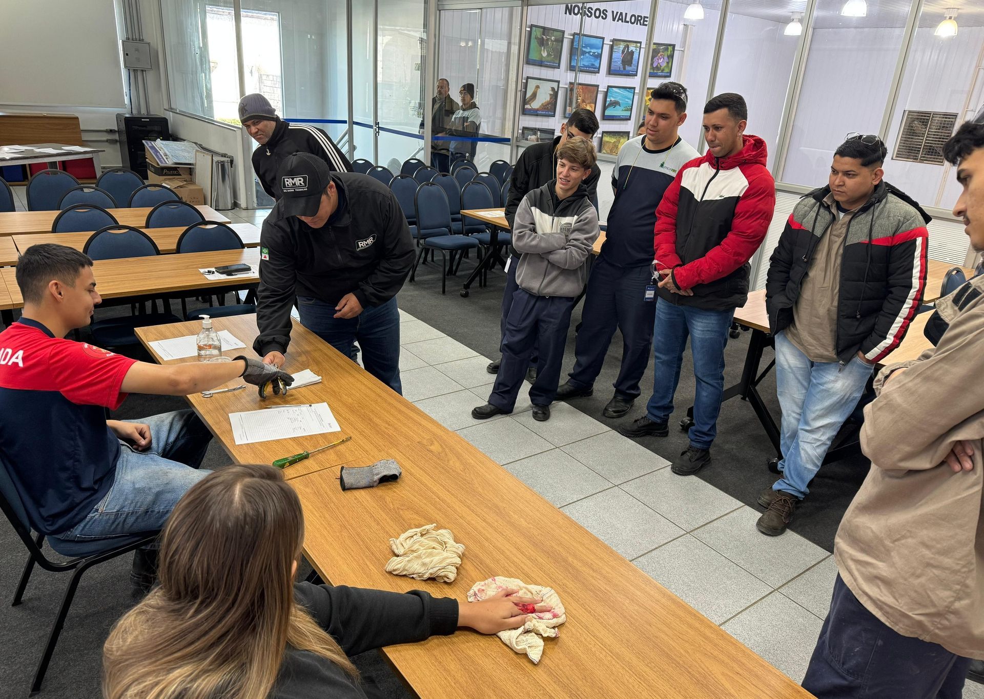 A group of people are standing around a table in a room.