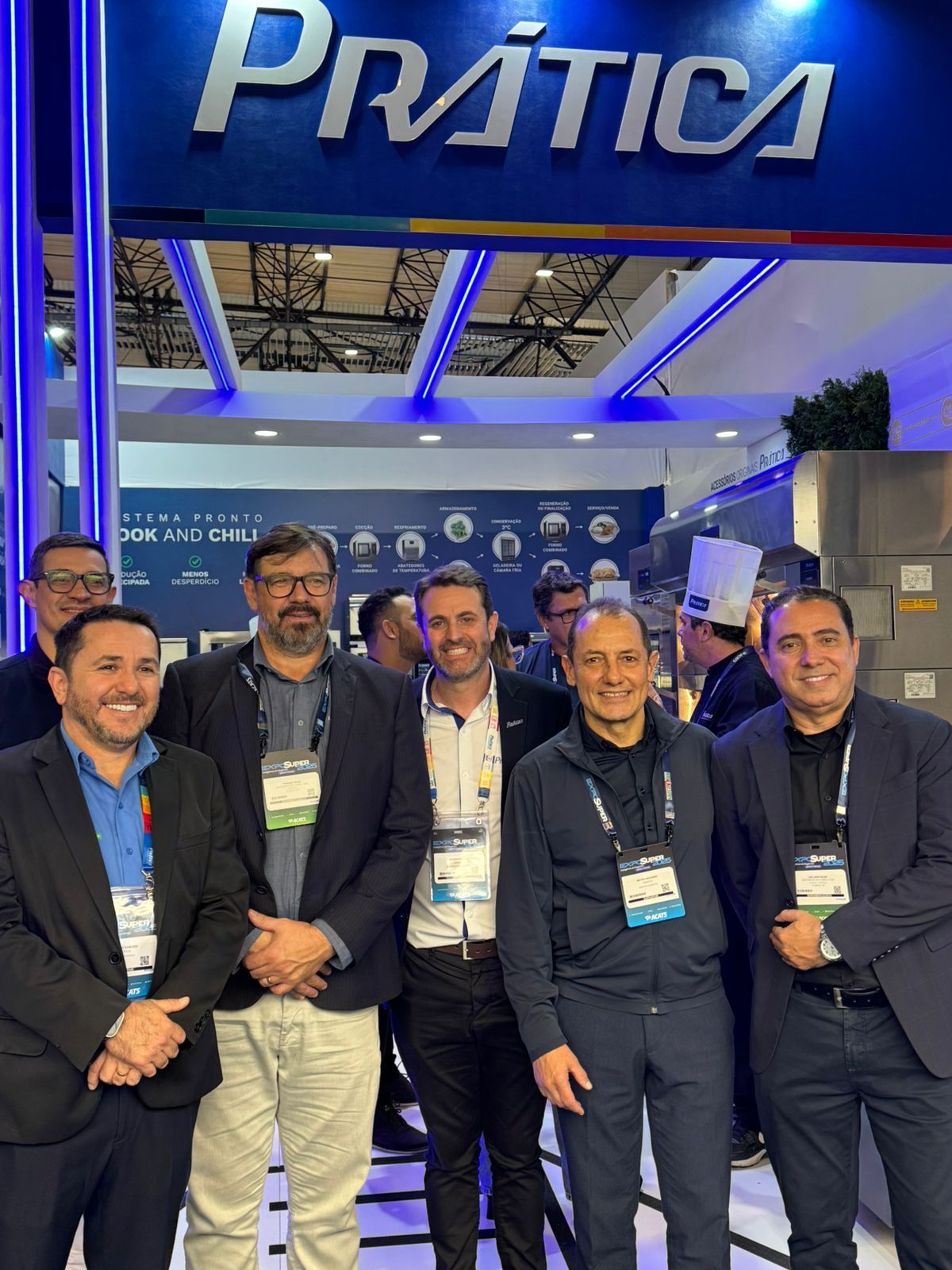 Um grupo de homens em pé em frente a uma placa de prática