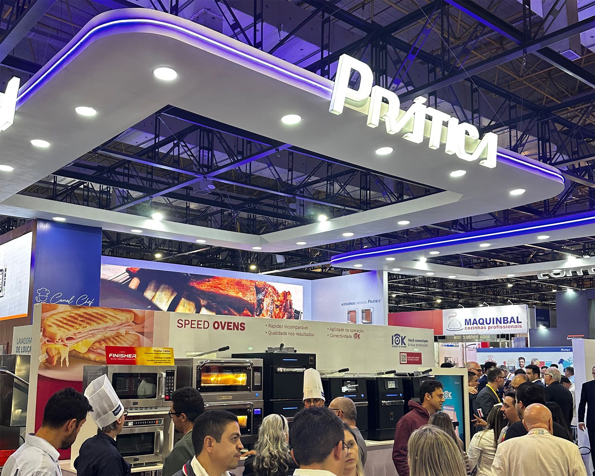 A group of people are standing under a sign that says prima on it.
