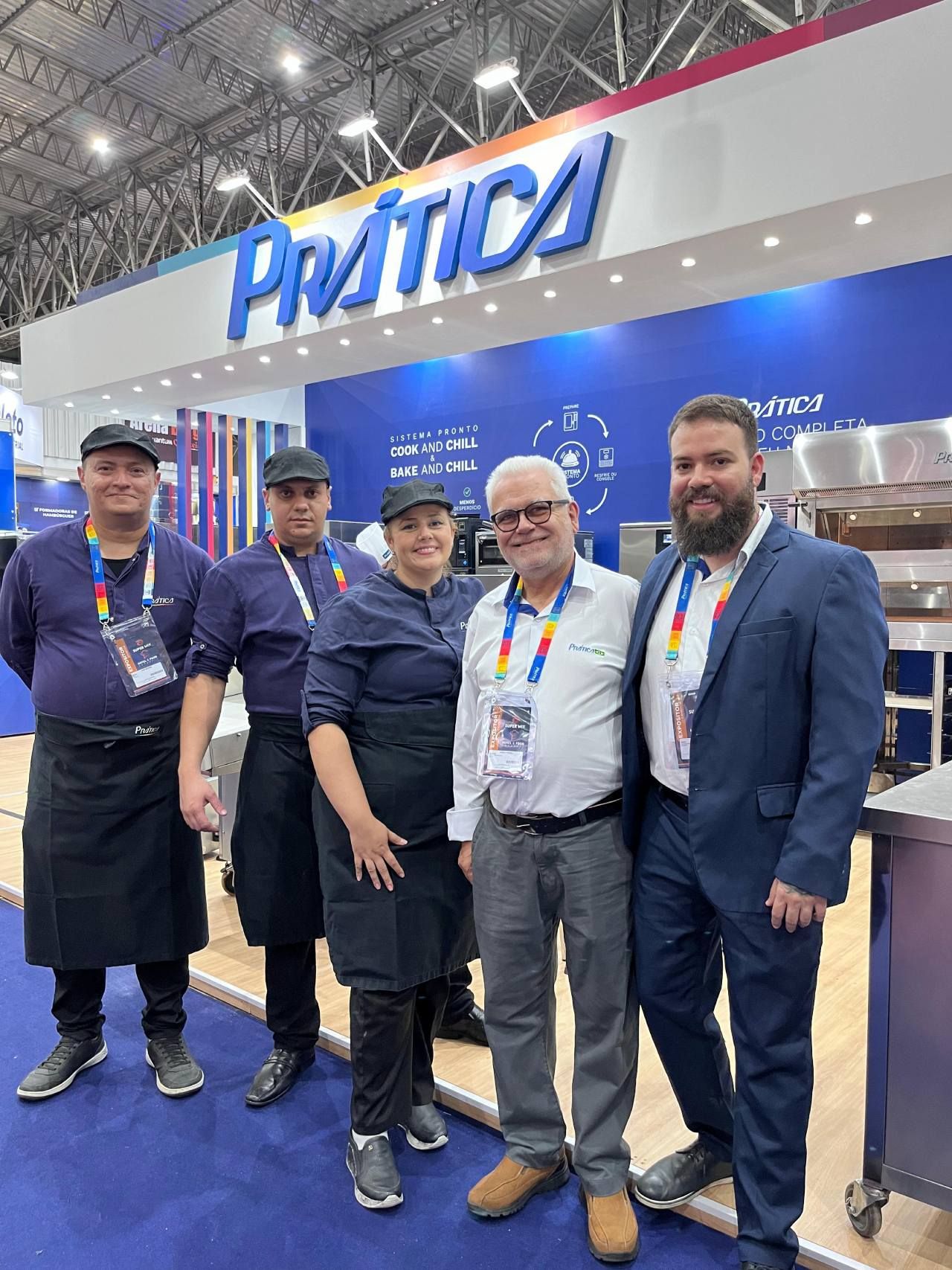 Um grupo de pessoas em pé em frente a uma placa que diz pratica.