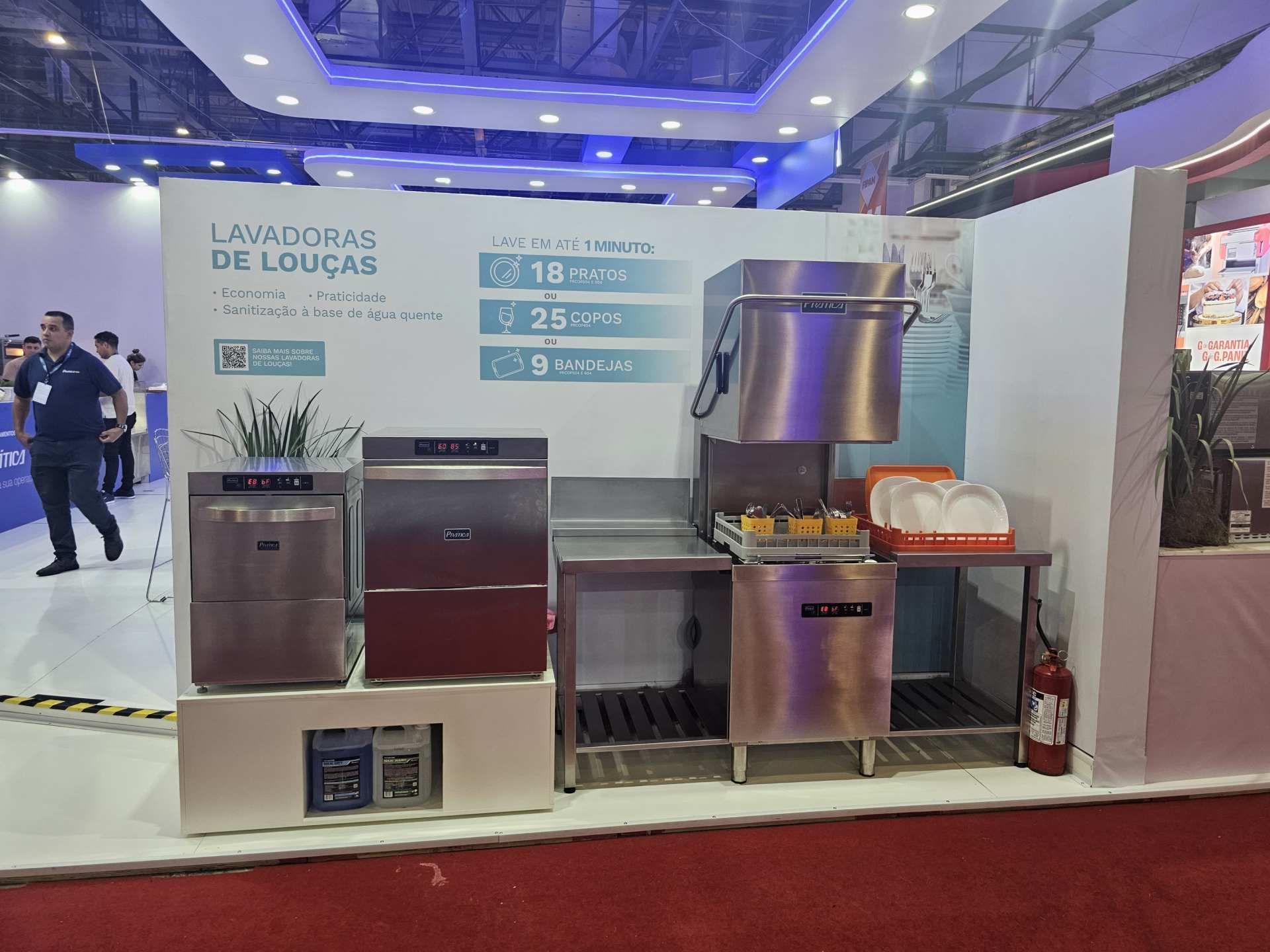 Uma exposição de máquinas de lavar louça de aço inoxidável em uma feira comercial.