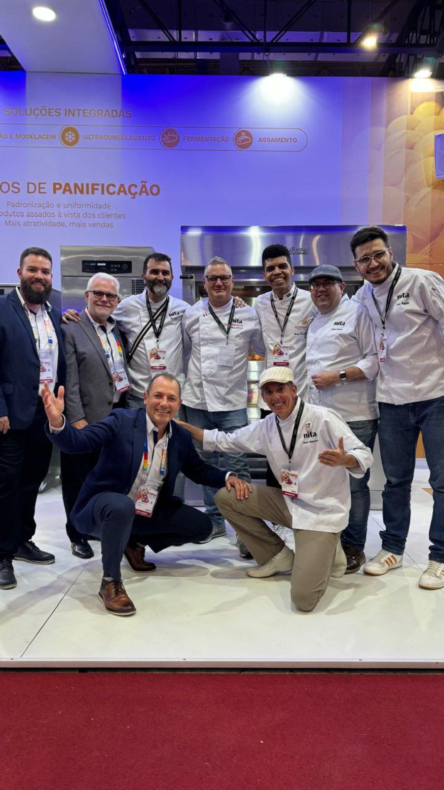 Um grupo de homens está posando para uma foto em uma convenção.