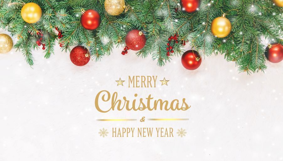 Christmas decoration with evergreen boughs, red and gold ornaments, and gold 