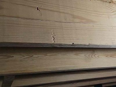 Close-up of weathered wooden planks with cracks and imperfections.