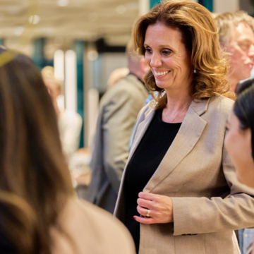 Judith smiling while casually talking with FIBO event attendees