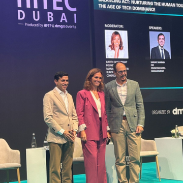 Judith taking photos with fellow speakers at a conference