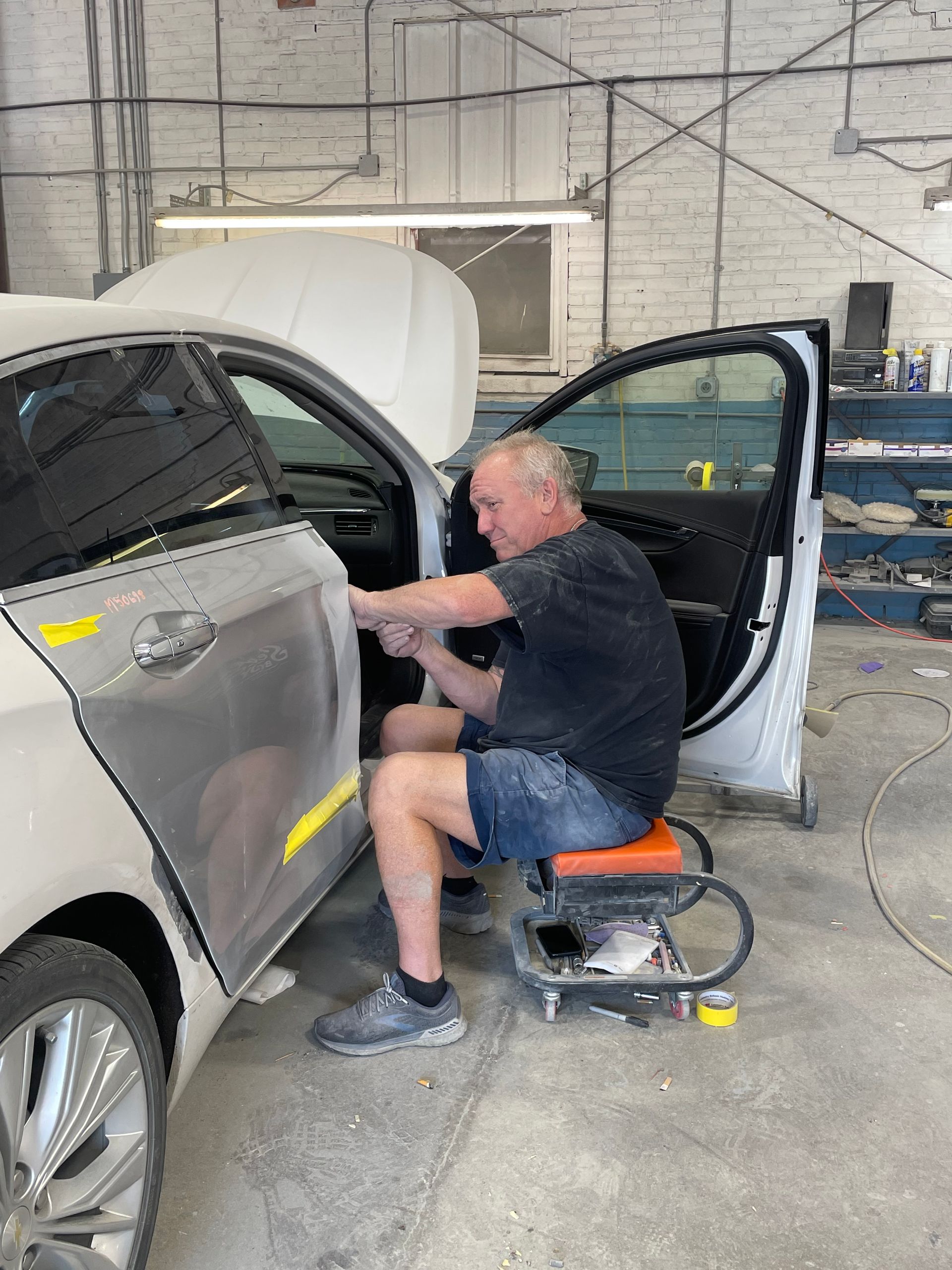 Man Repairing Car Door - NE, United States - Sealey Body Shop