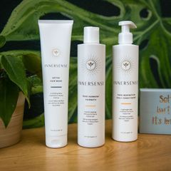 Three bottles of innersense are sitting on a table