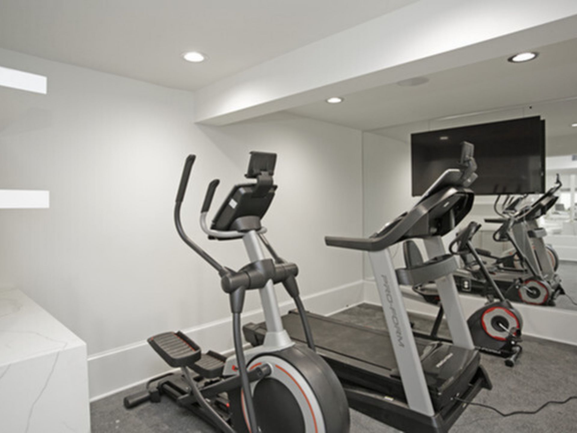 Overland Station apartment community newly remodeled fitness center with machines.