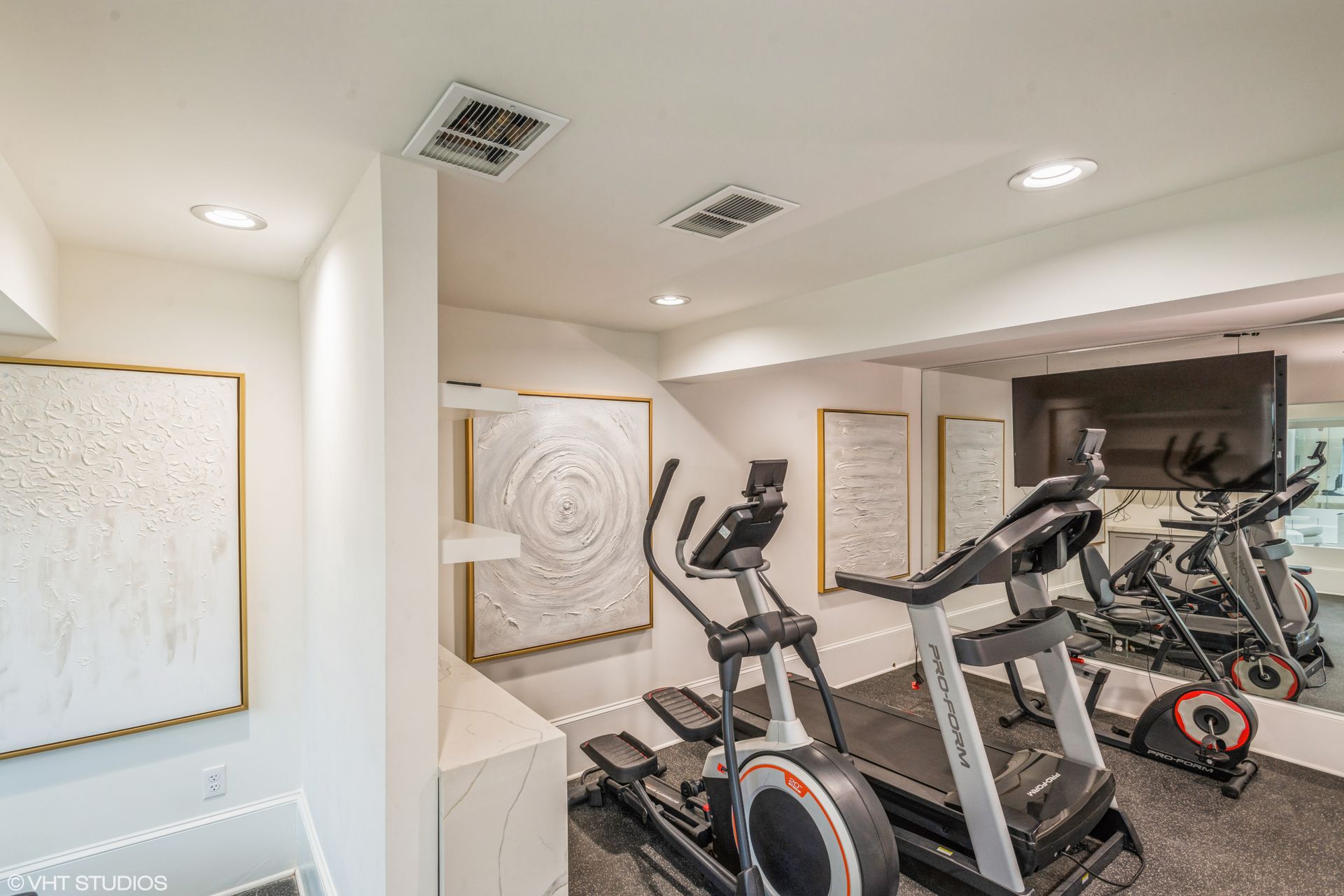 Overland Station apartment community fitness center with machines.