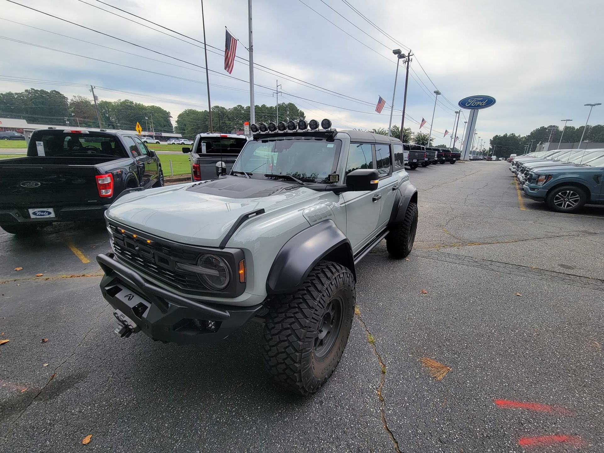 A Ford Bronco Raptor is parked in a parking lot