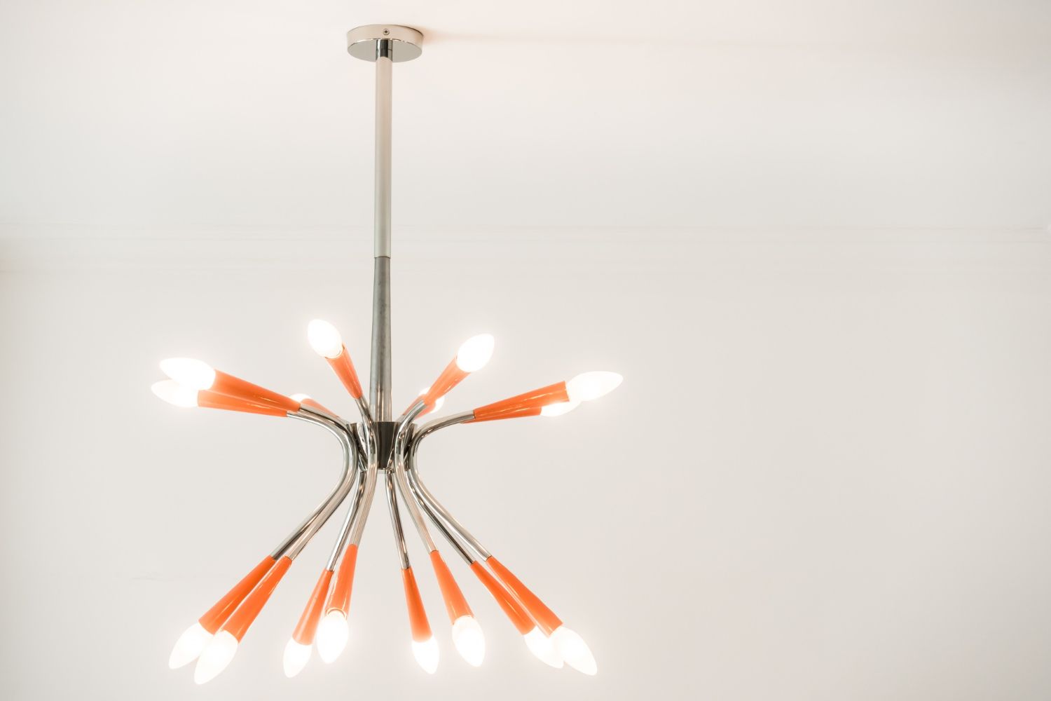 A chandelier with orange bulbs hanging from the ceiling