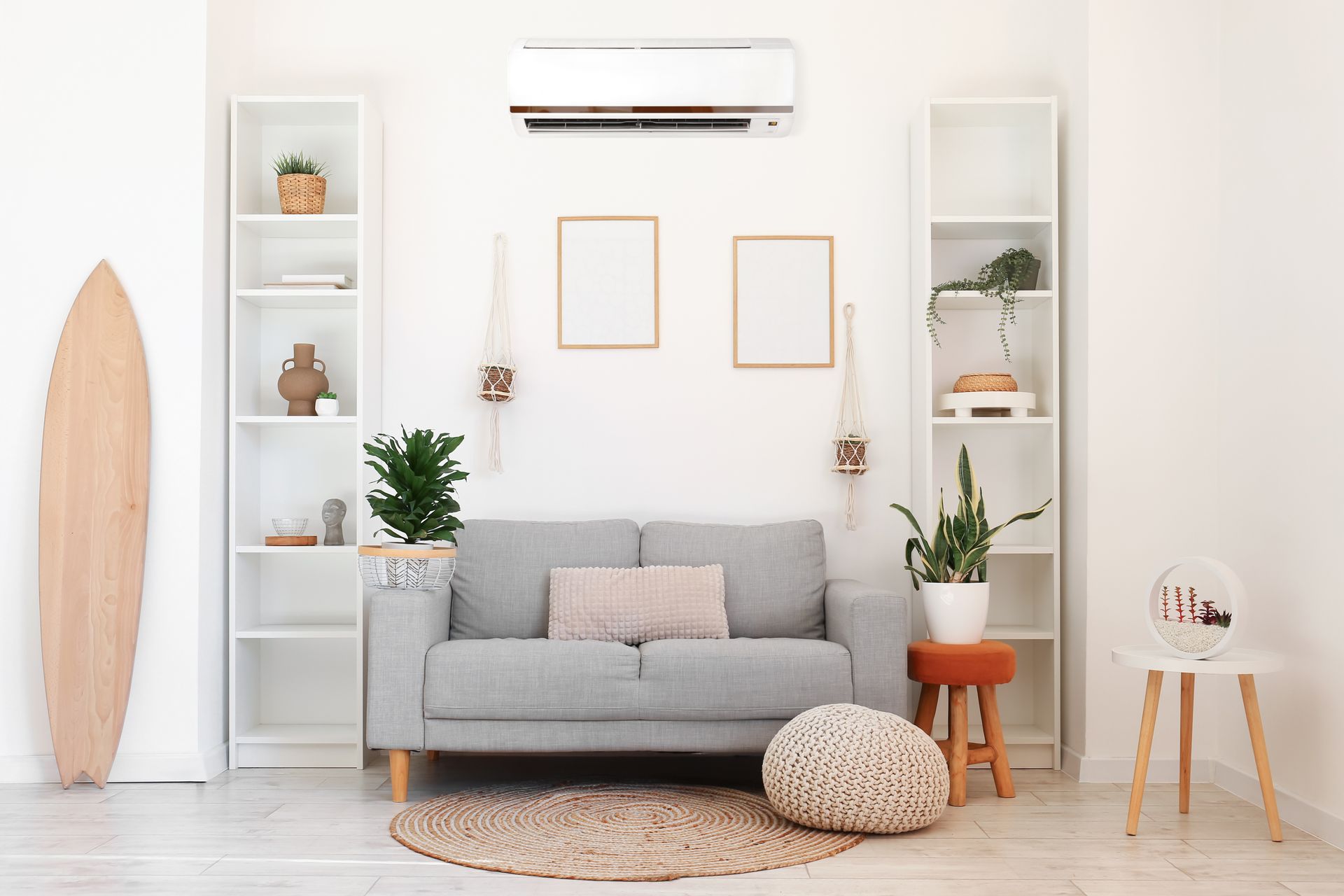 A woman is stretching her arms in front of a wall mounted air conditioner.