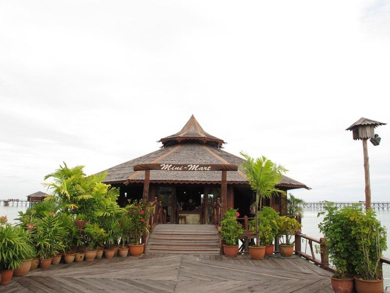 Wooden building with thatched roof over the water, 