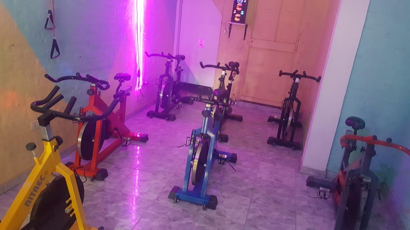 Bicicletas de spinning en una habitación con iluminación colorida.