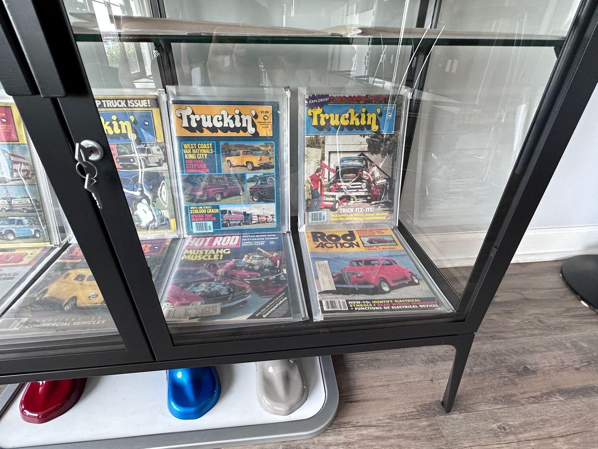 A glass display case filled with trucking magazines.
