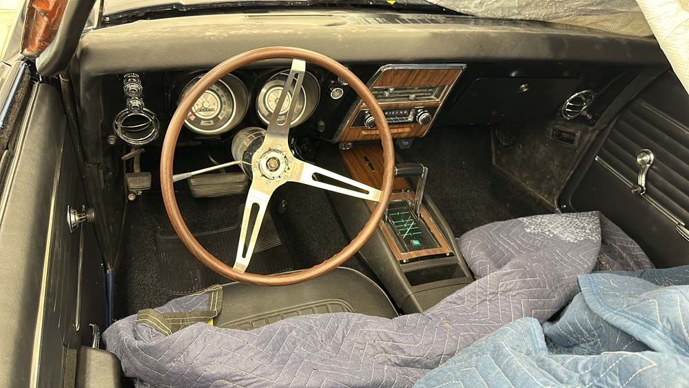 The inside of a car with a steering wheel and dashboard