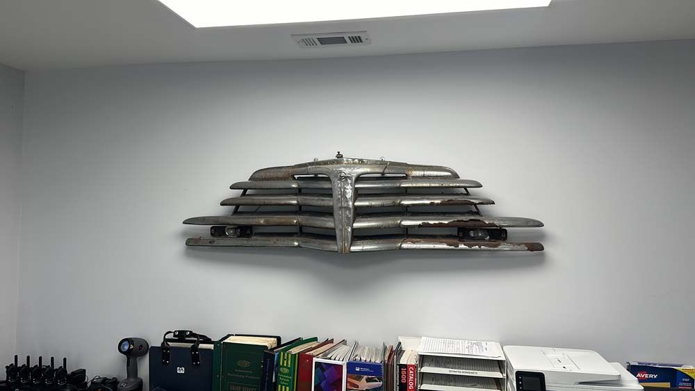 A shelf with a car grille on it in a room