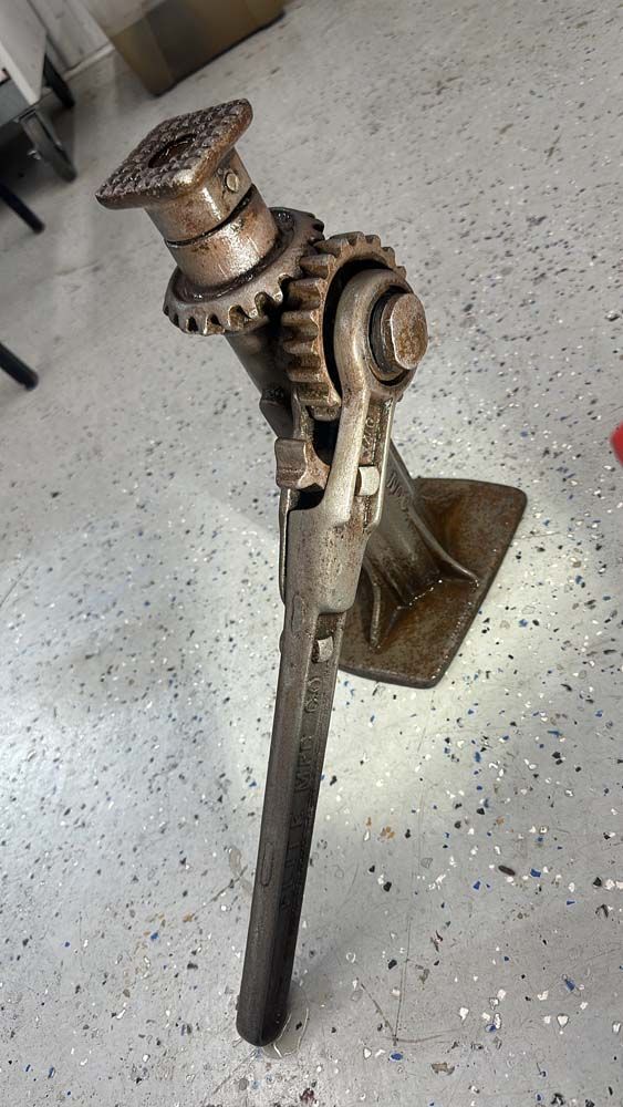 A large metal object is sitting on a concrete floor.