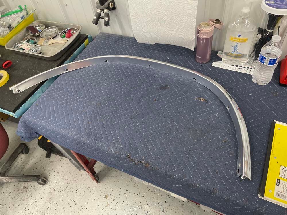 A piece of metal is sitting on top of a blue table cloth.