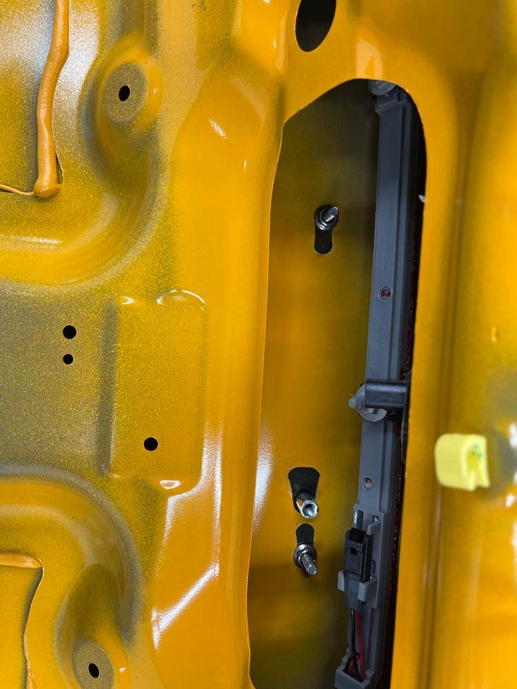 A close up of the inside of a yellow car.