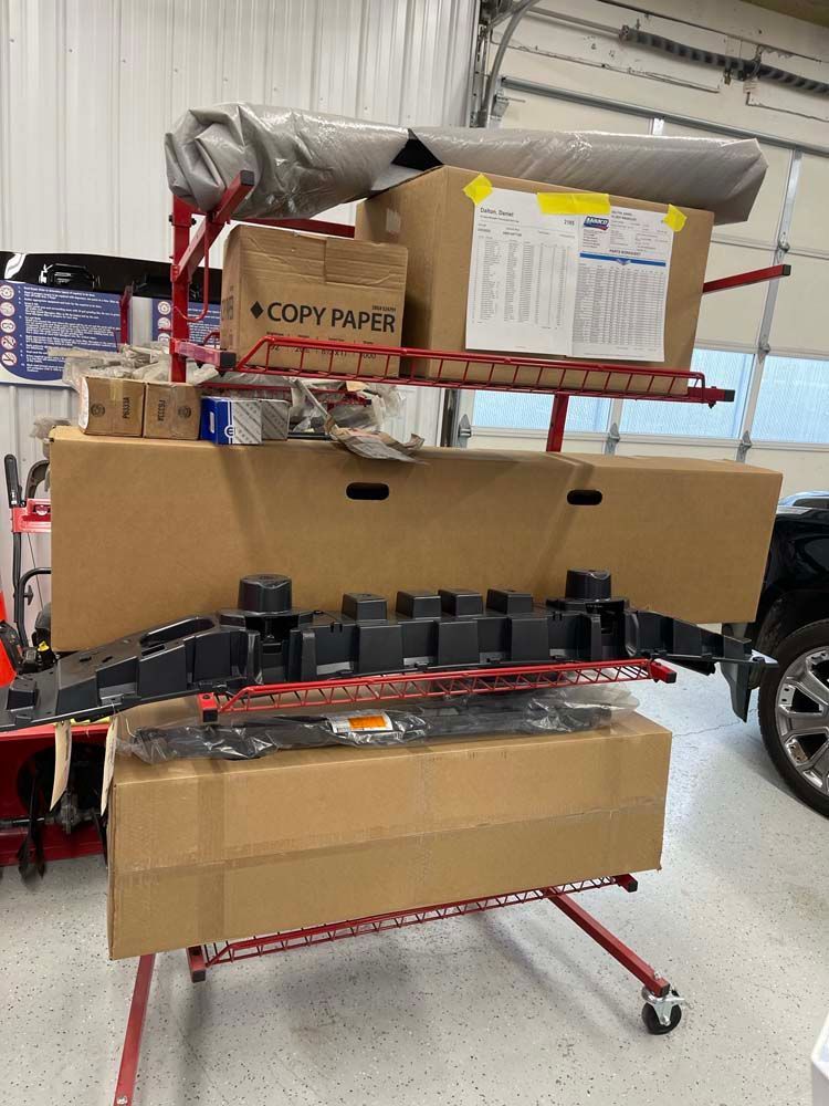 A bunch of boxes are sitting on a rack in a garage.