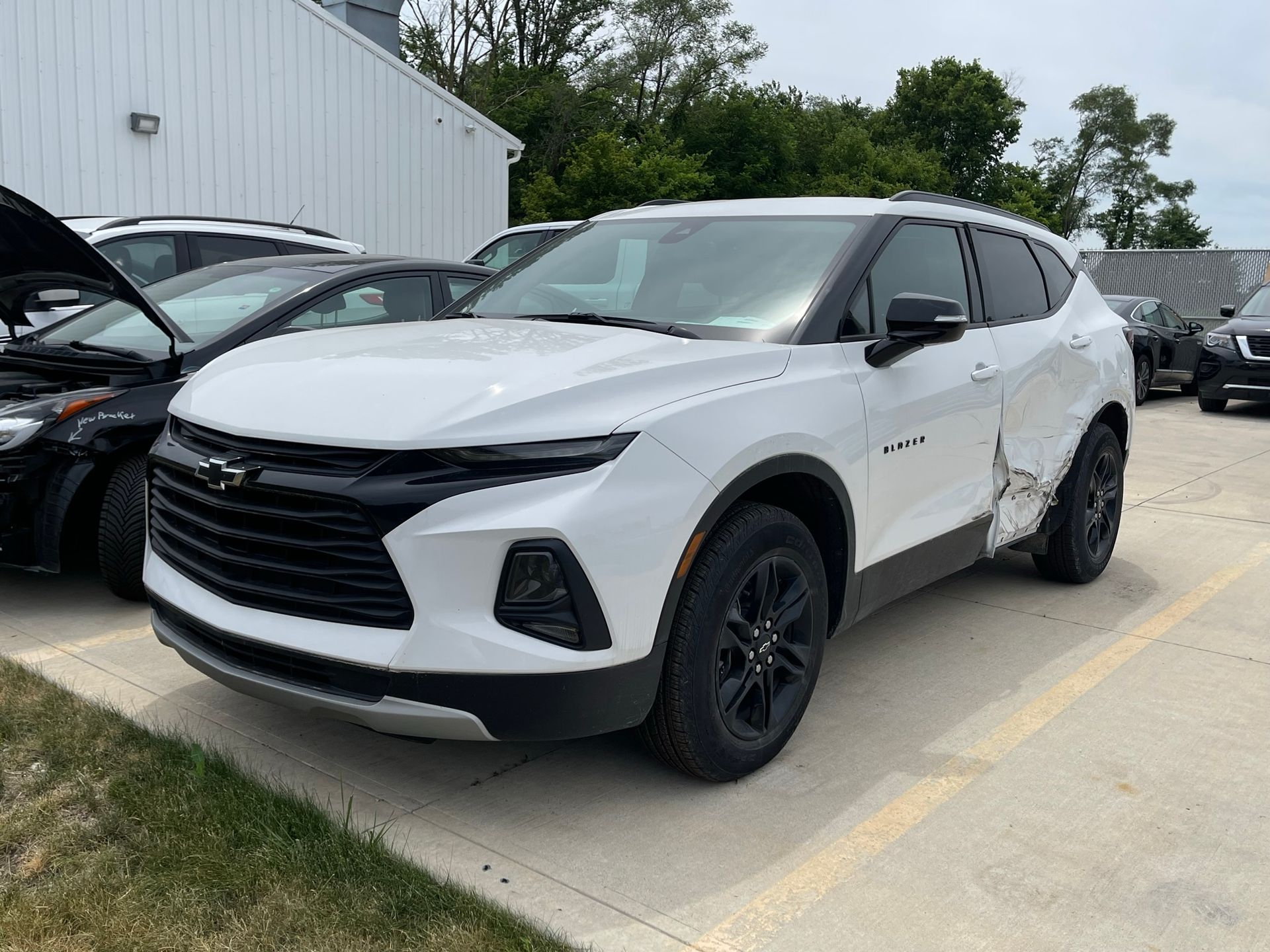 White Chevrolet Blazer SUV with black accents parked on pavement.