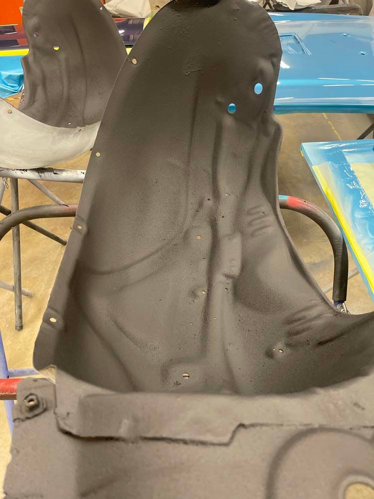 A black object is sitting on a table next to a chair.