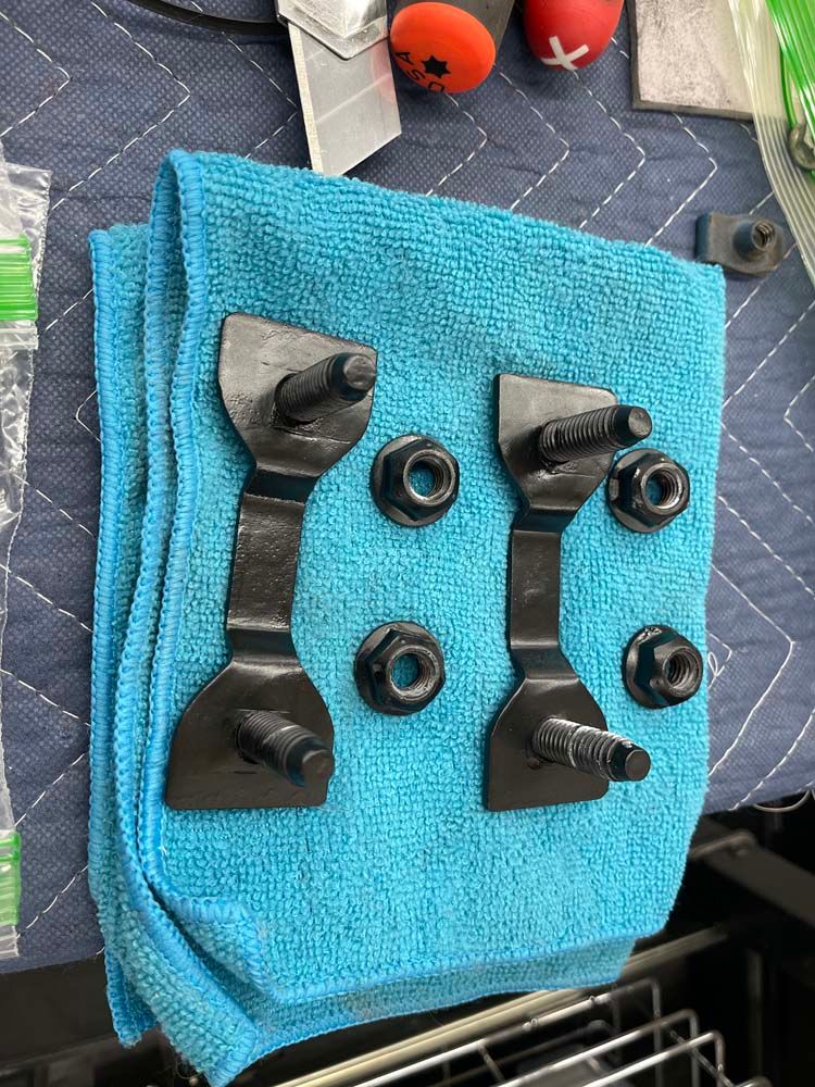 A blue towel with a bunch of nuts and bolts on it.