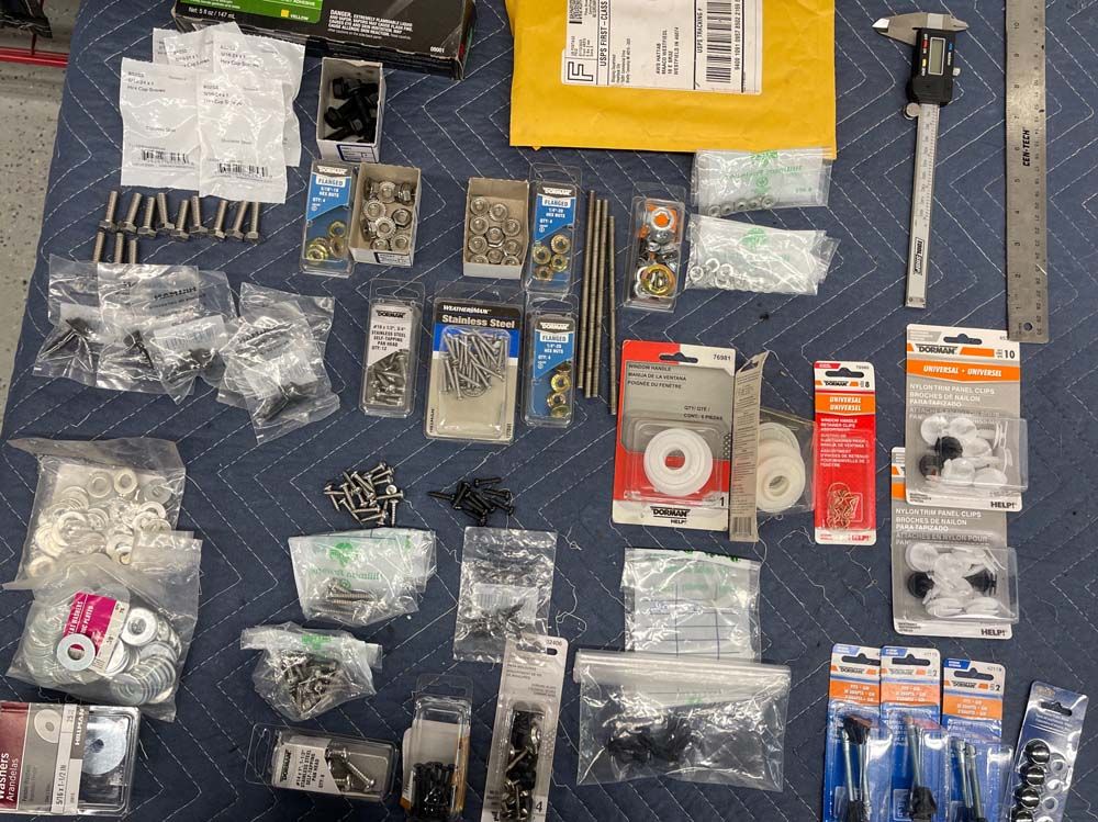 A table filled with lots of different types of hardware