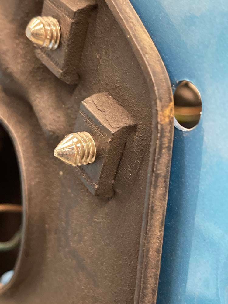 A close up of a piece of metal with screws on it.