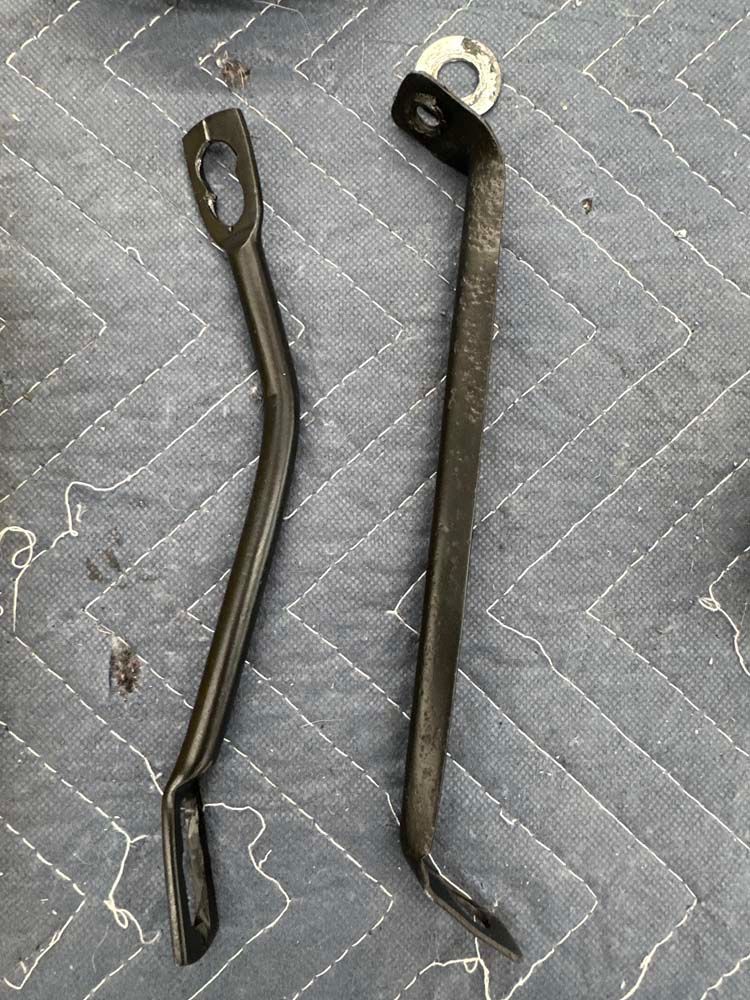 Two metal pieces are sitting on top of a blue blanket.