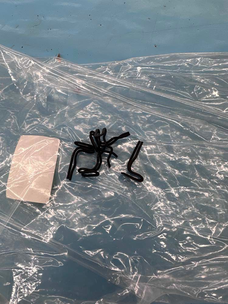 A spider is sitting on top of a plastic bag.