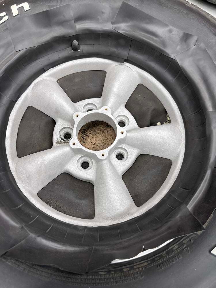 A close up of a tire with a tire cover on it.