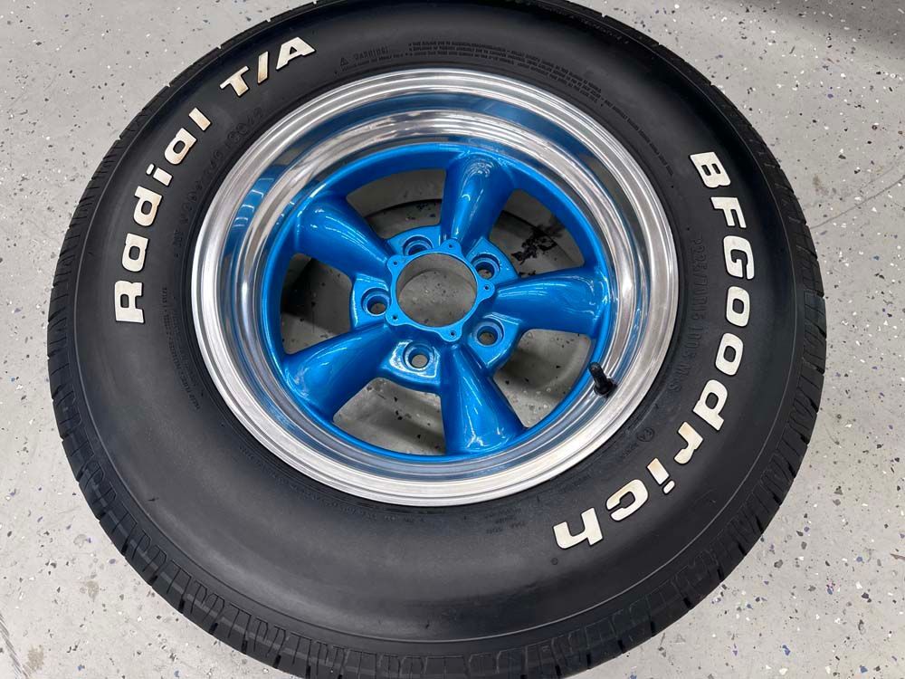 A bfgoodrich tire with a blue rim